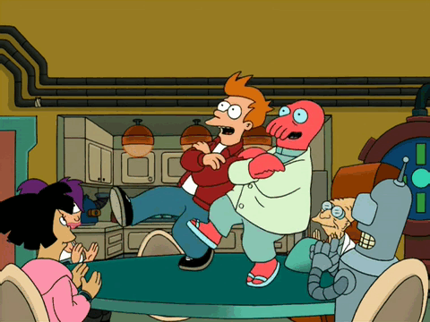 Fry and Zoidberg dancing together on a table